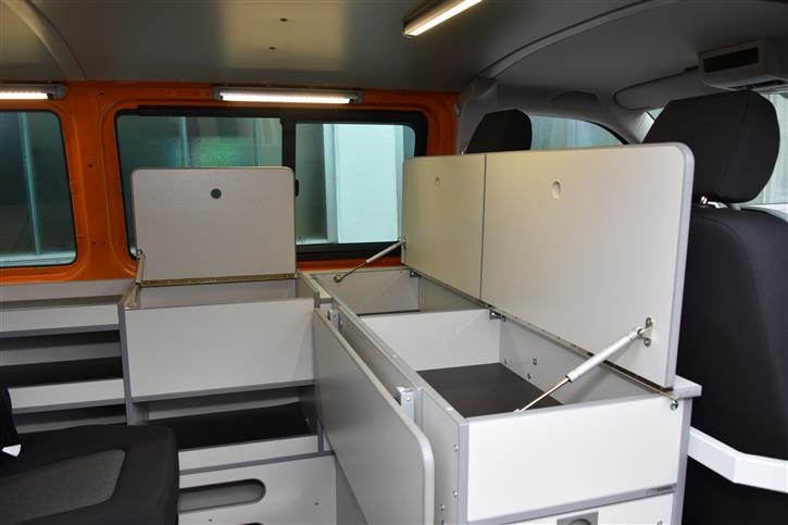Foldable writing surface (with gas pressure dampers) for comfortable acess of the compartments underneath 