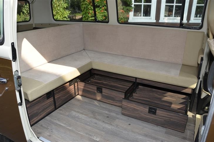 Parquet flooring and L-shaped seat group in 70s look 