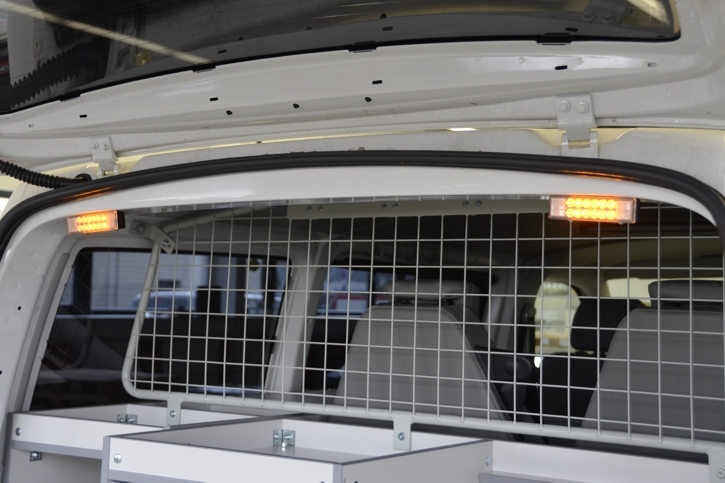 Protective grille and flashing warning lights in the rear