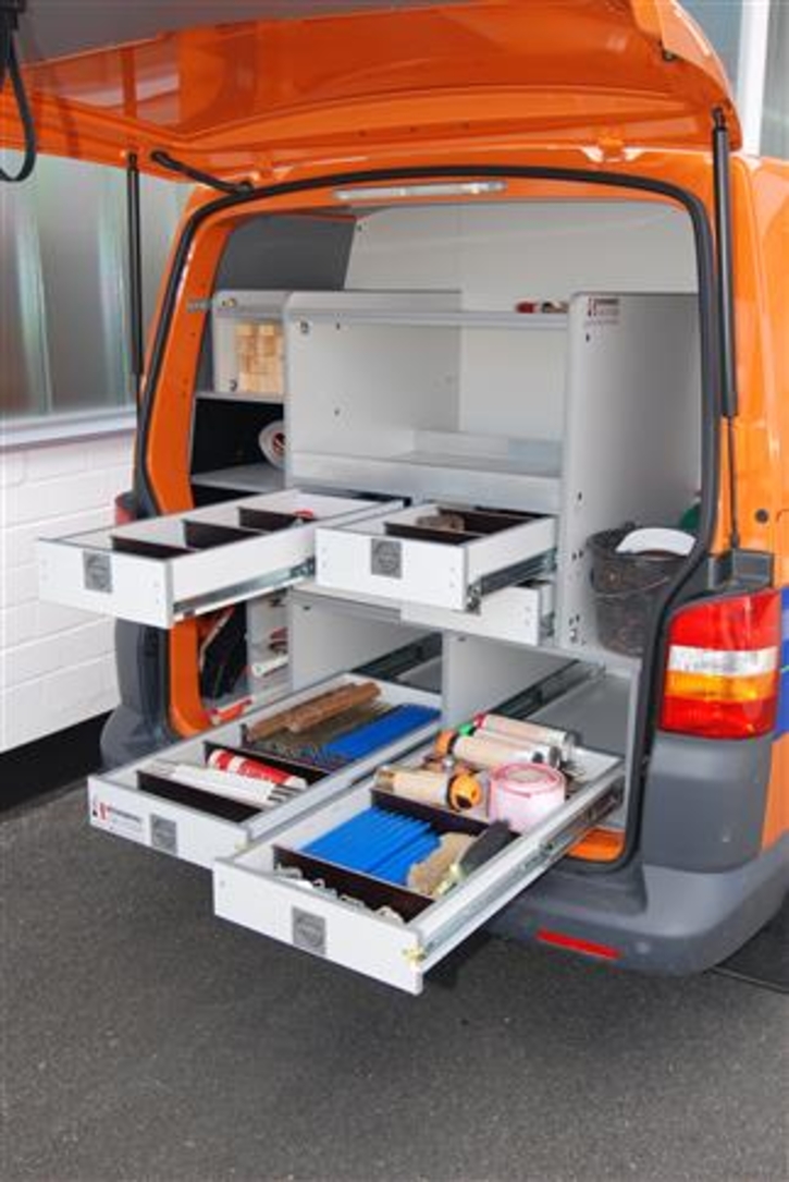 Rear interior with tripod compartments, drawers for small parts and shelves for tool boxes 