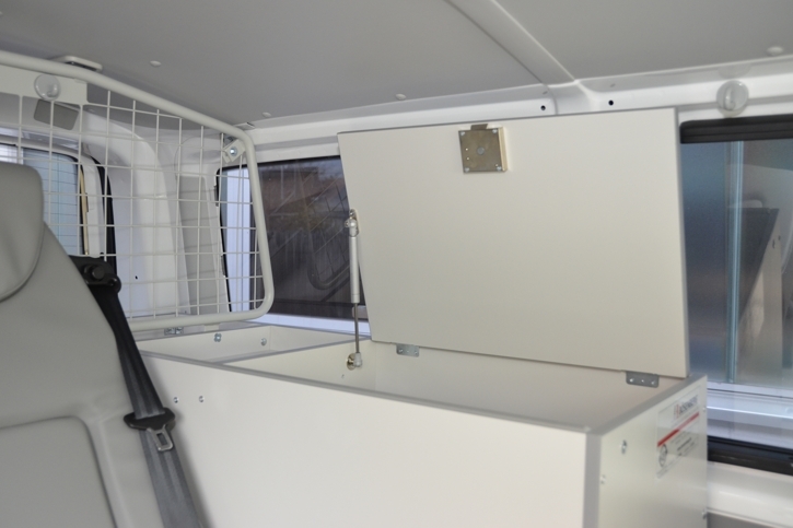 Storage compartment next to the seats 