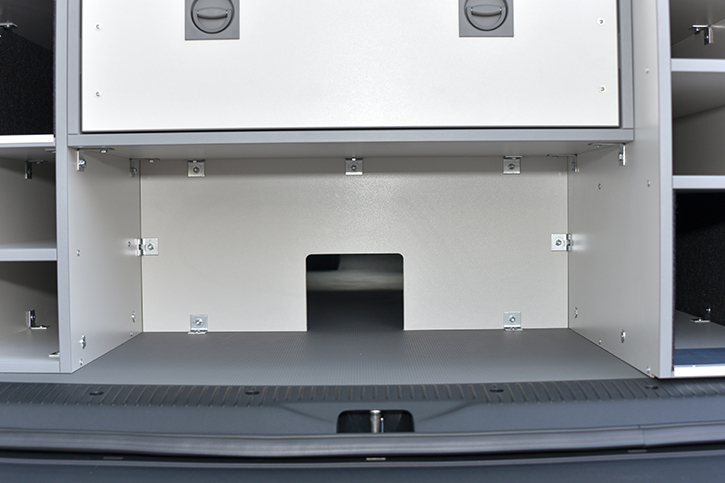 Storage compartment with load-through possibility 