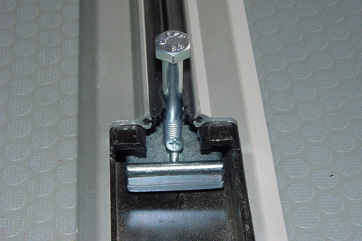 The universal adapter mounted to the seat rail 