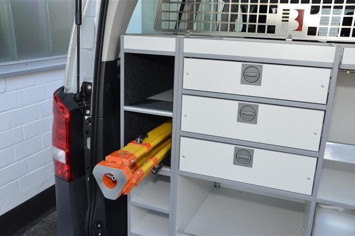 Tripod compartment with anti-slip mat, drawers for small parts and shelves for ranging poles up to a length of 2,5 m